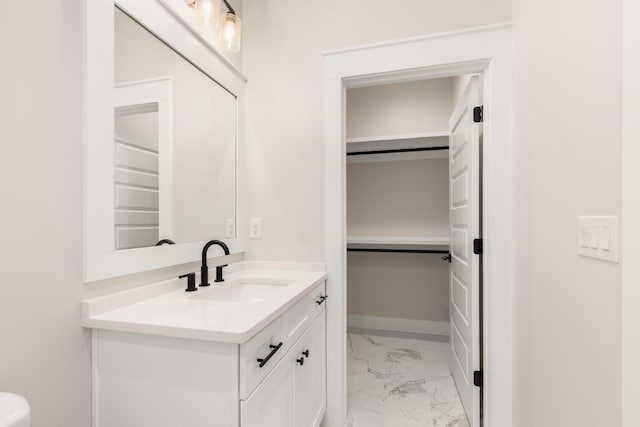 335 J Hunters Way S, Freeport, FL 32439 - bathroom featuring marble look tile flooring, vanity, and baseboards