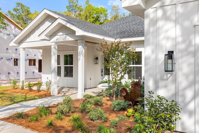 335 J Hunters Way S, Freeport, FL 32439 - doorway to property with board and batten siding, a shingled roof, and a porch