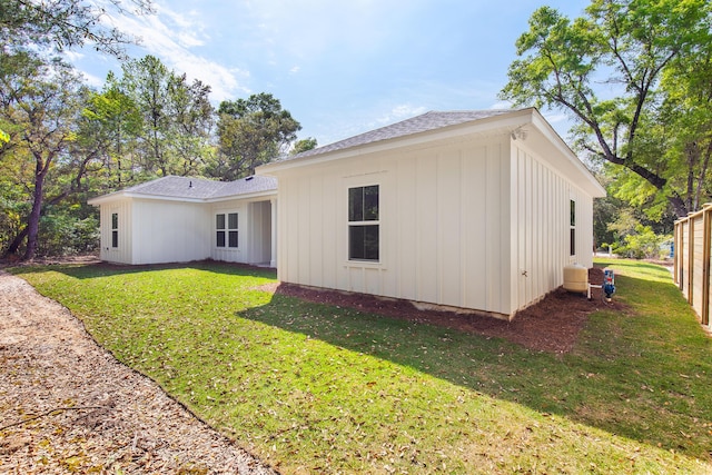 335 J Hunters Way S, Freeport, FL 32439 - back of house with board and batten siding, a lawn, and roof with shingles