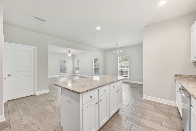74 Tranquility Ln, Santa Rosa Beach, FL 32459 - kitchen featuring stainless steel dishwasher, wood finish floors, a center island, open floor plan, and a chandelier