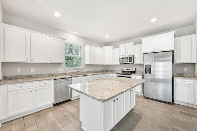 74 Tranquility Ln, Santa Rosa Beach, FL 32459 - kitchen featuring stainless steel appliances, light wood-style flooring, white cabinetry, a center island, and recessed lighting