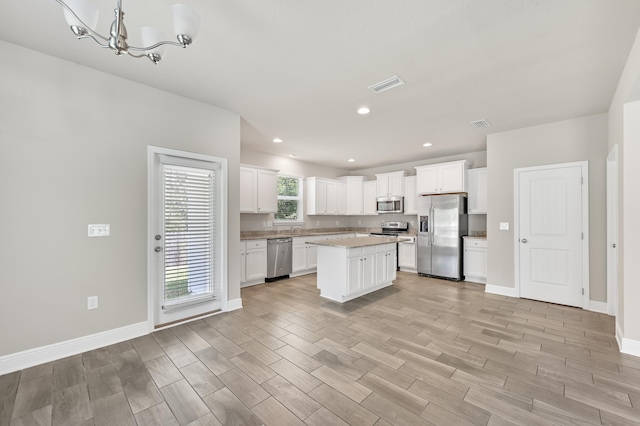 74 Tranquility Ln, Santa Rosa Beach, FL 32459 - kitchen featuring stainless steel appliances, light wood-style floors, light countertops, white cabinetry, and recessed lighting