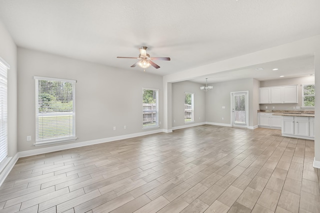 74 Tranquility Ln, Santa Rosa Beach, FL 32459 - unfurnished living room featuring ceiling fan, light wood-type flooring, a chandelier, and recessed lighting