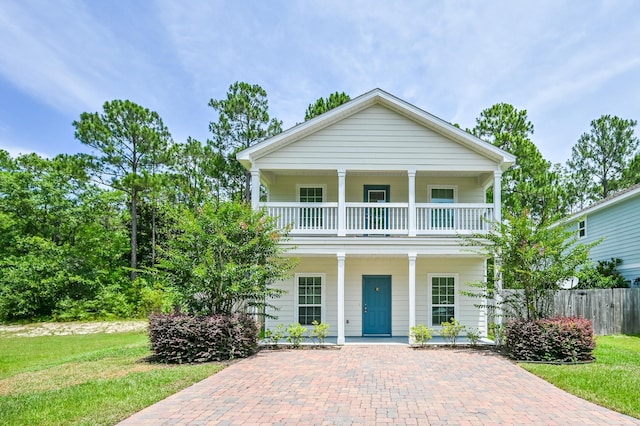 74 Tranquility Ln, Santa Rosa Beach, FL 32459 - greek revival house featuring a porch and a balcony