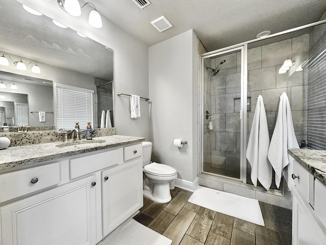74 Tranquility Ln, Santa Rosa Beach, FL 32459 - full bathroom with vanity, a shower stall, and wood finished floors