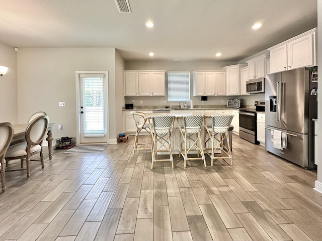 74 Tranquility Ln, Santa Rosa Beach, FL 32459 - kitchen featuring stainless steel appliances, healthy amount of natural light, a kitchen island, light wood finished floors, and recessed lighting