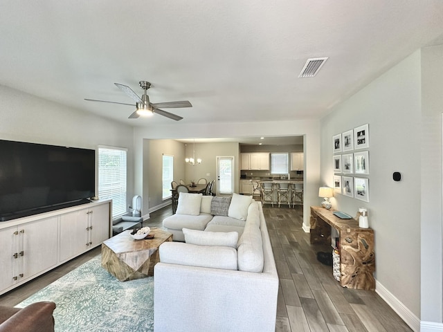 74 Tranquility Ln, Santa Rosa Beach, FL 32459 - living area with a ceiling fan, dark wood-style floors, and a chandelier
