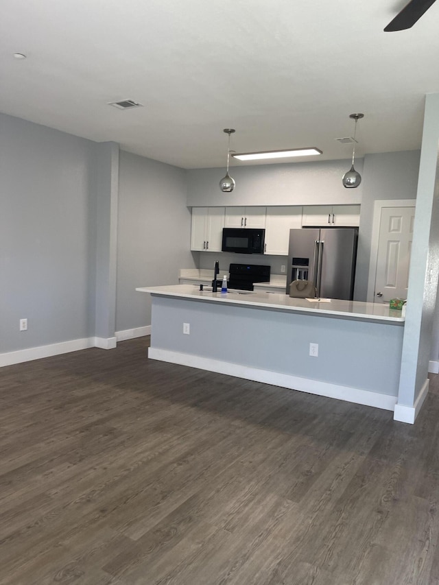 424 Ed St, Fort Walton Beach, FL 32547 - kitchen featuring stainless steel fridge, black microwave, dark wood finished floors, and light countertops