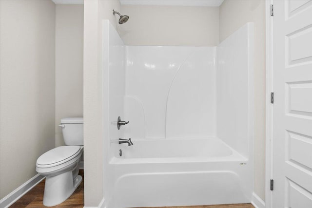 3158 Chestnut St, Crestview, FL 32539 - bathroom featuring toilet, shower / washtub combination, baseboards, and wood finished floors