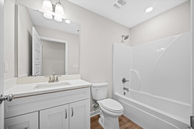 3158 Chestnut St, Crestview, FL 32539 - bathroom featuring toilet, vanity, bathtub / shower combination, and wood finished floors