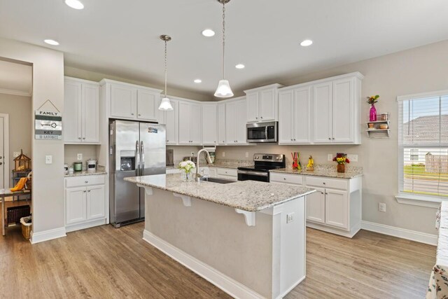 809 Whispering Creek Ave, Freeport, FL 32439 - kitchen with stainless steel appliances, light wood-type flooring, white cabinets, and recessed lighting