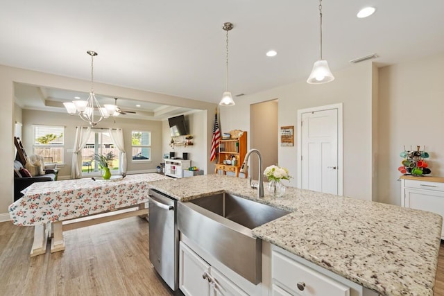 809 Whispering Creek Ave, Freeport, FL 32439 - kitchen featuring stainless steel dishwasher, light wood-style floors, a tray ceiling, open floor plan, and recessed lighting