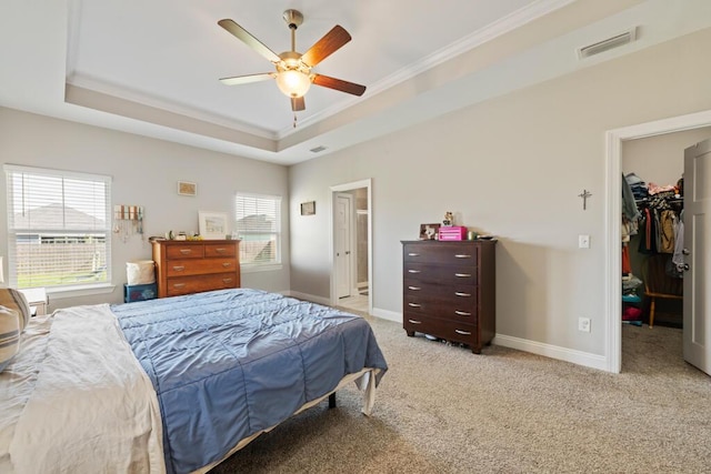 809 Whispering Creek Ave, Freeport, FL 32439 - bedroom with a walk in closet, ornamental molding, a tray ceiling, light colored carpet, and baseboards