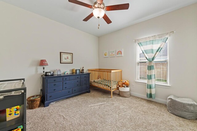 809 Whispering Creek Ave, Freeport, FL 32439 - bedroom featuring a nursery area, carpet flooring, ceiling fan, and baseboards