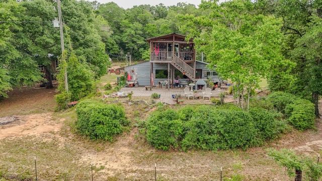 841 N 1st St, Defuniak Springs, FL 32433 - back of property featuring stairs, a patio, a wooden deck, and a wooded view