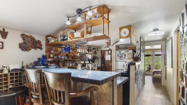 841 N 1st St, Defuniak Springs, FL 32433 - bar featuring tile patterned flooring, freestanding refrigerator, and extractor fan