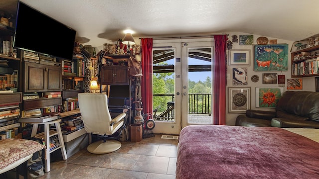 841 N 1st St, Defuniak Springs, FL 32433 - bedroom with access to outside, vaulted ceiling, french doors, and a textured ceiling