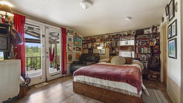 841 N 1st St, Defuniak Springs, FL 32433 - bedroom featuring access to outside, vaulted ceiling, a textured ceiling, and french doors