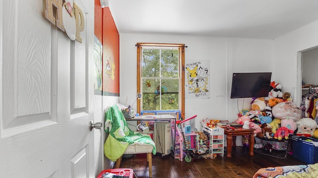 841 N 1st St, Defuniak Springs, FL 32433 - playroom with wood-type flooring and radiator heating unit