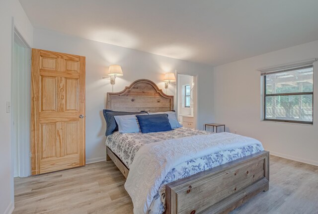 3892 Belmar Pl, Chipley, FL 32428 - bedroom with light wood-style floors, multiple windows, and baseboards