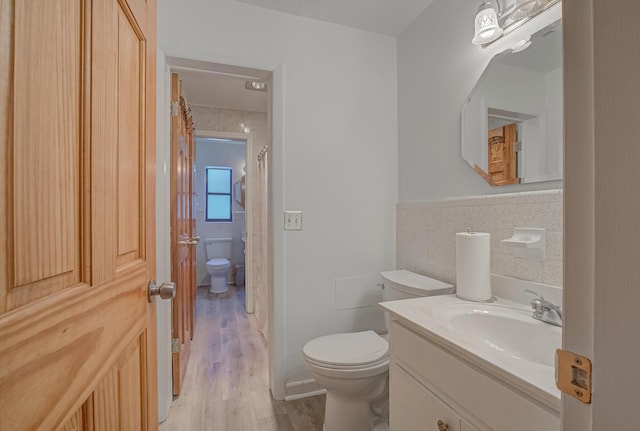 3892 Belmar Pl, Chipley, FL 32428 - bathroom featuring tile walls, toilet, wood finished floors, vanity, and a shower with curtain