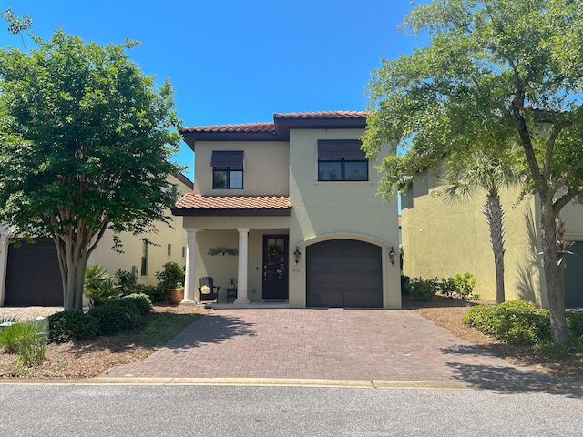 1976 Baytowne Loop, Miramar Beach, FL 32550 - mediterranean / spanish home featuring a tile roof, stucco siding, decorative driveway, and an attached garage