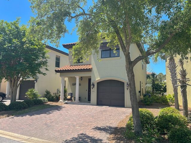 1976 Baytowne Loop, Miramar Beach, FL 32550 - mediterranean / spanish home with decorative driveway, a garage, stucco siding, and a tile roof