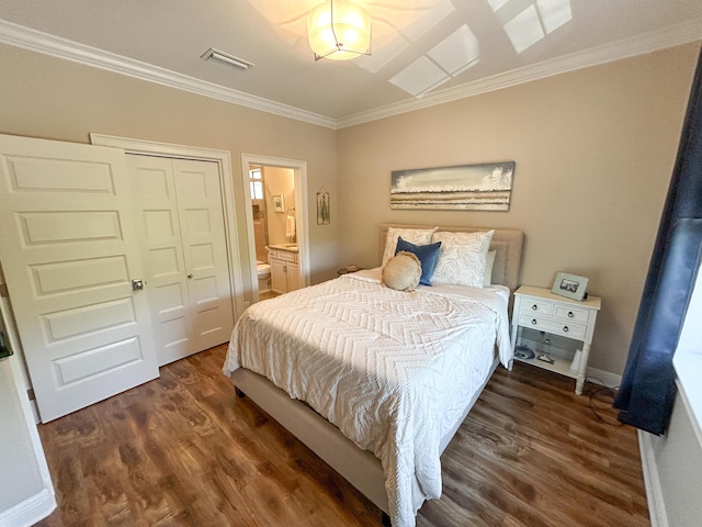 1976 Baytowne Loop, Miramar Beach, FL 32550 - bedroom with ornamental molding, wood finished floors, ensuite bathroom, and a closet