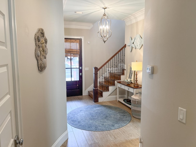1976 Baytowne Loop, Miramar Beach, FL 32550 - entrance foyer featuring a chandelier, wood finished floors, crown molding, and stairs