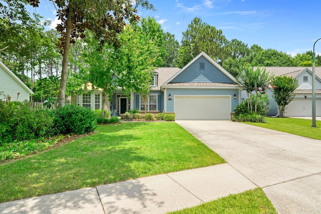 53 Concert Ct, Freeport, FL 32439 - view of front of property featuring a garage, driveway, a front lawn, and a shingled roof