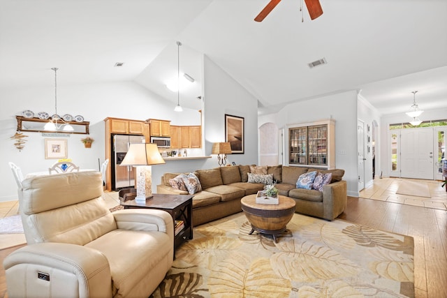 53 Concert Ct, Freeport, FL 32439 - living area featuring a ceiling fan, light wood finished floors, baseboards, a chandelier, and high vaulted ceiling