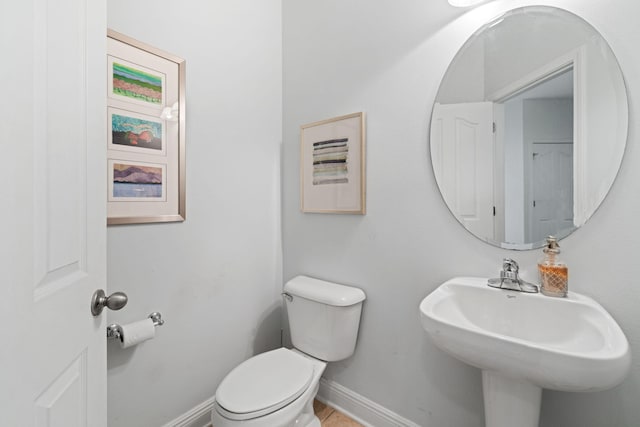 53 Concert Ct, Freeport, FL 32439 - half bath featuring toilet, baseboards, and a sink