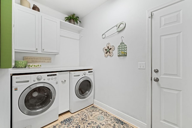 53 Concert Ct, Freeport, FL 32439 - laundry room with washing machine and dryer, cabinet space, baseboards, and light tile patterned floors
