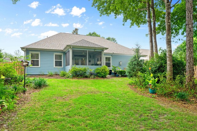 53 Concert Ct, Freeport, FL 32439 - rear view of property featuring a sunroom, a yard, and a shingled roof