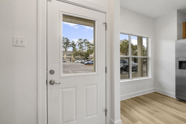 15284 331 Business Unit 11B, Freeport, FL 32439 - doorway with baseboards and light wood-style flooring