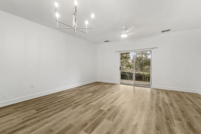 15284 331 Business Unit 11B, Freeport, FL 32439 - unfurnished room with a chandelier, a ceiling fan, light wood finished floors, and baseboards