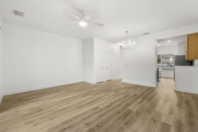 15284 331 Business Unit 11B, Freeport, FL 32439 - unfurnished living room with a chandelier, ceiling fan, light wood-style flooring, baseboards, and recessed lighting