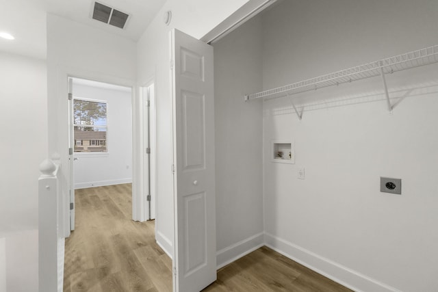 15284 331 Business Unit 11B, Freeport, FL 32439 - washroom with hookup for an electric dryer, washer hookup, light wood finished floors, and baseboards