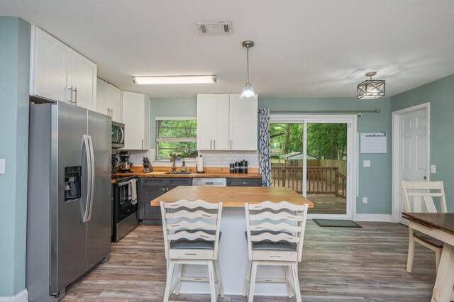 544 Purl Adams Ave, Crestview, FL 32539 - kitchen featuring appliances with stainless steel finishes, butcher block countertops, a sink, white cabinets, and light wood-style flooring
