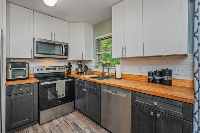 544 Purl Adams Ave, Crestview, FL 32539 - kitchen with appliances with stainless steel finishes, wooden counters, a sink, and white cabinets