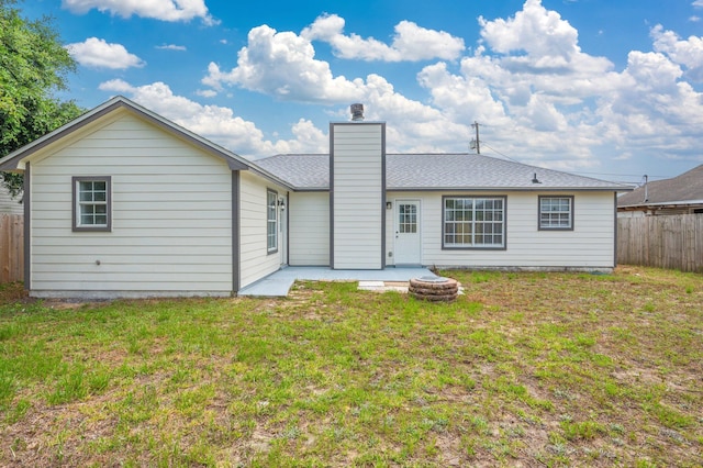 2129 Hillary Ln, Navarre, FL 32566 - rear view of house with a chimney and a patio