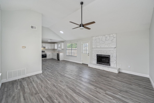 2129 Hillary Ln, Navarre, FL 32566 - unfurnished living room featuring a ceiling fan, a fireplace, wood finished floors, baseboards, and high vaulted ceiling