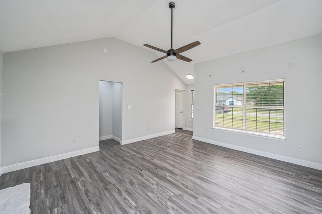2129 Hillary Ln, Navarre, FL 32566 - unfurnished living room with a ceiling fan, wood finished floors, baseboards, and high vaulted ceiling