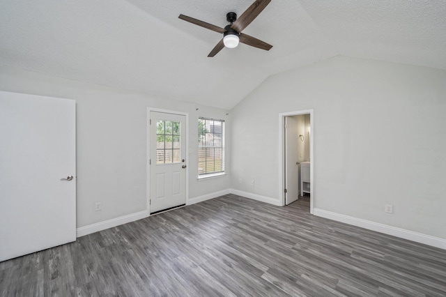 2129 Hillary Ln, Navarre, FL 32566 - empty room featuring ceiling fan, wood finished floors, vaulted ceiling, baseboards, and a textured ceiling