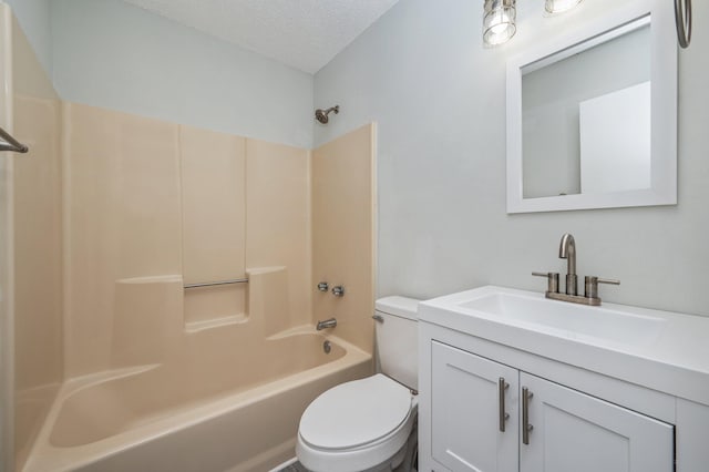 2129 Hillary Ln, Navarre, FL 32566 - bathroom with toilet, vanity, a textured ceiling, and washtub / shower combination
