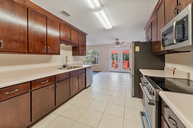 4555 Wolf Track Rdg Unit 6.44Ac, Crestview, FL 32539 - kitchen with a sink, appliances with stainless steel finishes, a textured ceiling, light countertops, and light tile patterned floors