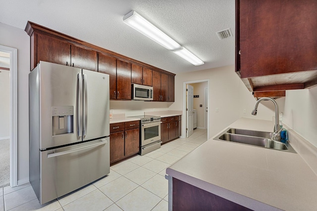 4555 Wolf Track Rdg Unit 6.44Ac, Crestview, FL 32539 - kitchen with stainless steel appliances, a sink, light tile patterned flooring, a textured ceiling, and light countertops