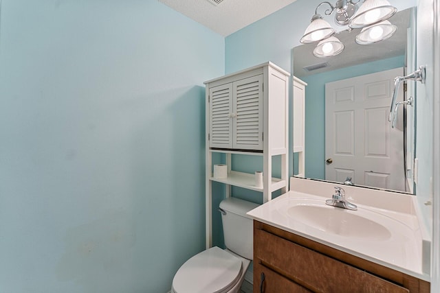 4555 Wolf Track Rdg Unit 6.44Ac, Crestview, FL 32539 - half bath featuring toilet, vanity, a chandelier, and a textured ceiling