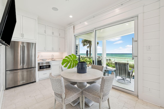 323 Pompano St, Inlet Beach, FL 32461 - dining space with recessed lighting, a water view, and stone tile floors
