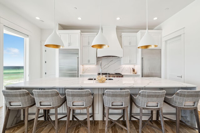 323 Pompano St, Inlet Beach, FL 32461 - kitchen with high end fridge, custom range hood, a large island, dark wood-style floors, and backsplash